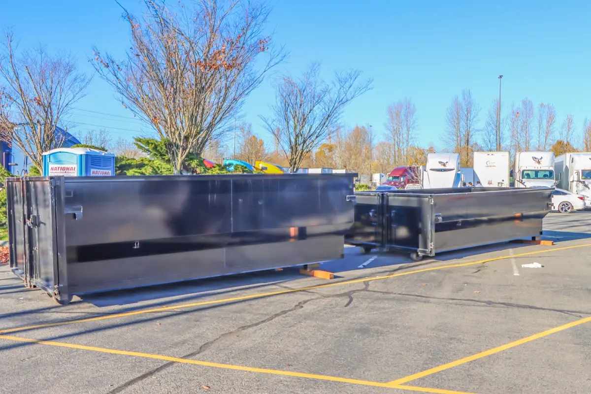 Professional dumpster rental service with roll-off container on residential driveway in Castle Rock